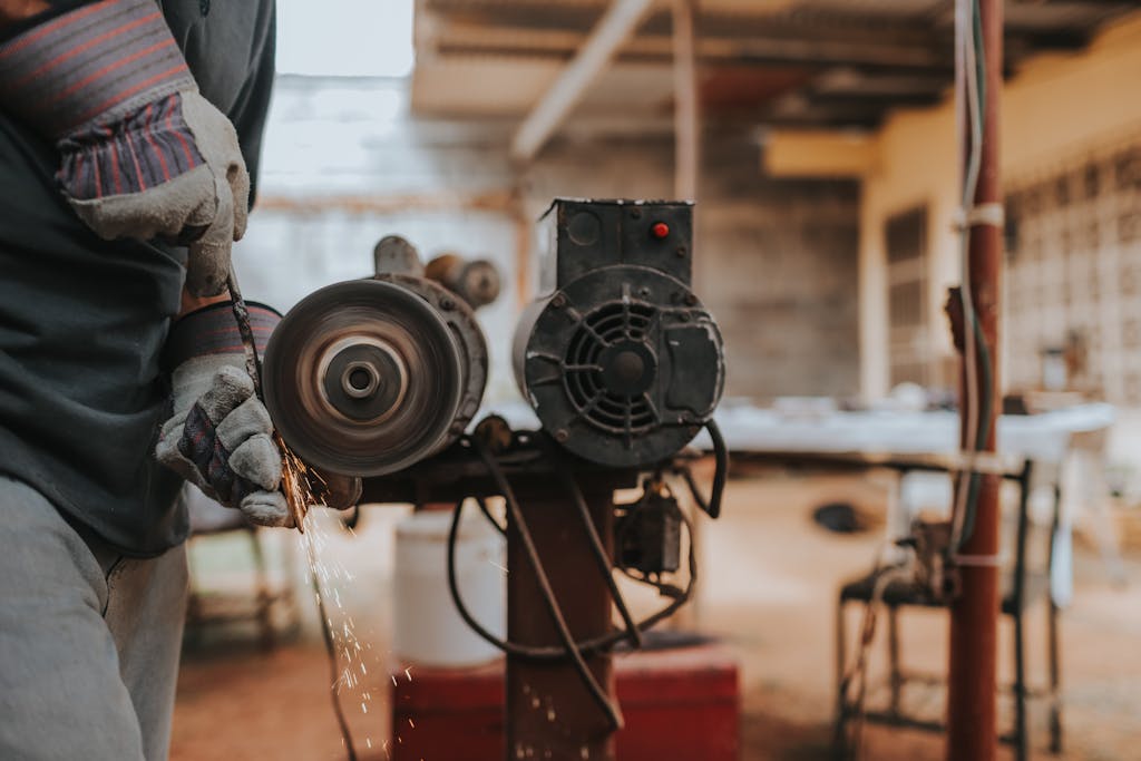 Guide to Using Diesel Heaters Indoors 1 A worker skillfully operates a grinder in a workshop, emitting sparks.